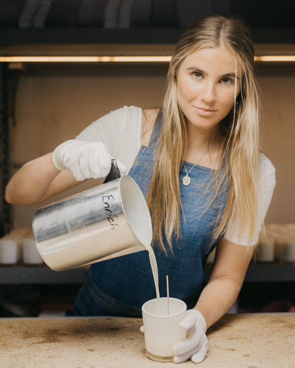 Hand pouring candles in the Byron Bay Candles factory